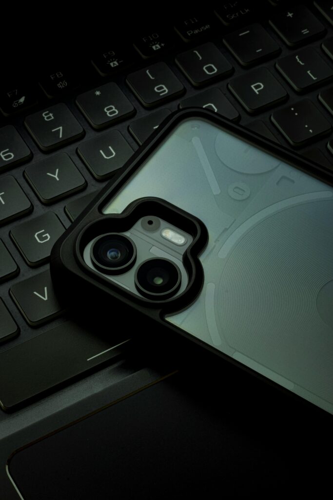 Close-up shot of a sleek smartphone resting on a laptop keyboard, capturing modern technology.